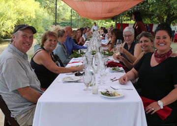 people at a long table - upscale outdoor dining at six sigma ranch