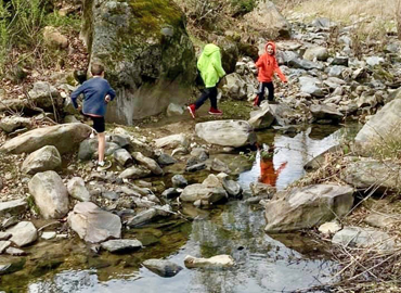 Kids hiking in creek