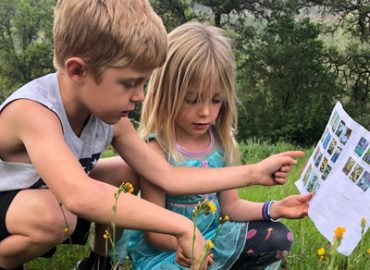 Grandkids studying flower guide